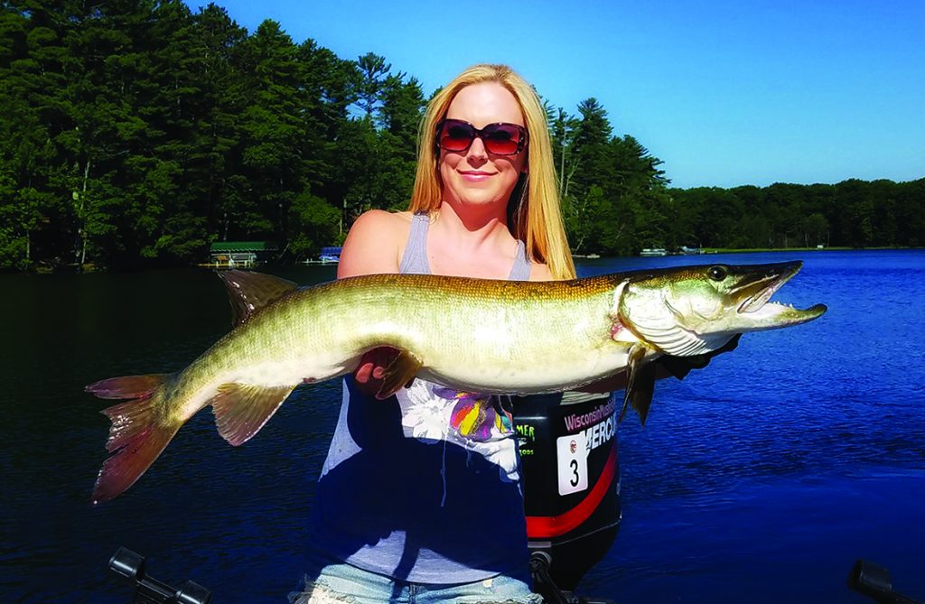 Maureen O'Brien holds a nice musky caught from a small lake while fishing with the author.